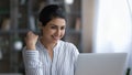 Smiling Indian woman work online on laptop Royalty Free Stock Photo