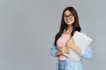 Smiling indian young woman student holding laptop isolated on grey background Royalty Free Stock Photo