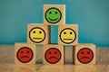 smiling, indifferent and sad emoticons on a blue background. satisfaction concept Royalty Free Stock Photo