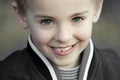 Smiling innocent kid with perfect blue eyes Royalty Free Stock Photo