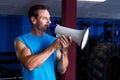 Smiling instructor holding megaphone Royalty Free Stock Photo