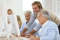Smiling instructor with seniors in class training Royalty Free Stock Photo