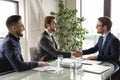 Smiling international businessmen handshake closing deal at meeting Royalty Free Stock Photo