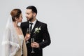 Smiling interracial couple in wedding clothes