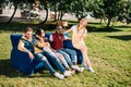 smiling interracial friends resting on blue sofa together Royalty Free Stock Photo