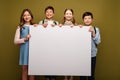 Smiling interracial kids with backpacks holding Royalty Free Stock Photo