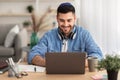 Smiling israeli man working on laptop at home Royalty Free Stock Photo