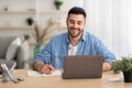 Smiling israeli man working on laptop at home Royalty Free Stock Photo