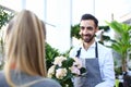 Smiling italian man seller of flowers stretches Royalty Free Stock Photo