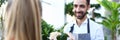 Smiling italian man seller of flowers stretches Royalty Free Stock Photo