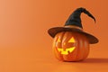 Smiling Jack-o\'-lantern with Witch\'s Hat on Orange Background Royalty Free Stock Photo