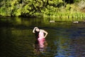 Smiling Japanese American Woman Standing In River With Geese Royalty Free Stock Photo