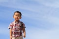 Smiling Japanese boy under the blue sky in summer Royalty Free Stock Photo
