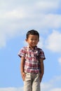 Smiling Japanese boy under the blue sky Royalty Free Stock Photo