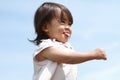 Smiling Japanese girl under the blue sky Royalty Free Stock Photo