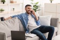 Smiling jew man working and talking on phone at home