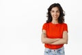 Smiling jewish brunette girl, cross arms on chest confident and relaxed, looking left at logo with satisfied face