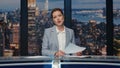 Smiling journalist presenting news at night studio closeup. Anchor woman talking