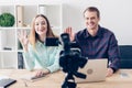 Smiling journalists recording vlog and waving hands Royalty Free Stock Photo