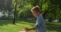 Smiling joyful boy put shuttlecock on racket. Kid play badminton on sunny day. Royalty Free Stock Photo