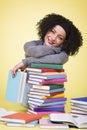 Smiling joyful girl along with multicolored books. Royalty Free Stock Photo