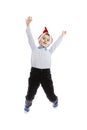 Smiling jumping schoolboy in Santa`s hat. Full height. Christmas mood. Isolated over white background.