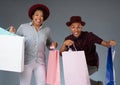 Smiling jumping young couple with shopping bags