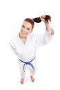 Smiling karate girl holding her ponytail Royalty Free Stock Photo