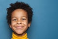 Smiling kid boy portrait. Little african american child boy on blue background Royalty Free Stock Photo