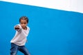 Smiling kid boy portrait. Little african american child boy posing on blue background, wall Royalty Free Stock Photo