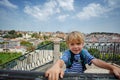 Smiling kid boy on viewpoint enjoy Lisbon breathtaking views Royalty Free Stock Photo