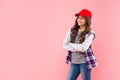 smiling kid with curly hair in cap. teen hipster beauty hairstyle. female casual fashion model. Royalty Free Stock Photo
