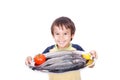 Smiling kid with fresh fish on table Royalty Free Stock Photo