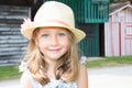 kid girl five year old posing outdoors Looking camera Childhood Closeup portrait of blonde child with straw hat Royalty Free Stock Photo