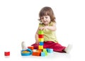 Smiling kid girl playing building block toys