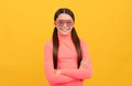 smiling kid in glamour party eyeglasses on yellow background, fancy look