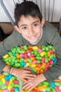 Smiling kid playng with colorful corn toys