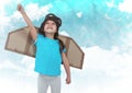 Smiling kid pretending to be a pilot against clouds