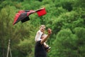 Smiling kid. Running with red kite. Child sitting on the man`s shoulders. Having fun