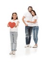 smiling kid showing red paper heart with parents hugging behind Royalty Free Stock Photo