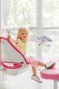 smiling kid showing thumb up while waiting for dentist