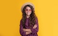 smiling kid in straw hat and sunglasses with long brunette curly hair on yellow background Royalty Free Stock Photo