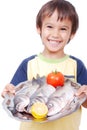 Smiling kid with three fresh fishes on table Royalty Free Stock Photo