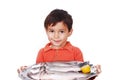 Smiling kid with three fresh fishes on table Royalty Free Stock Photo