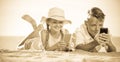 Smiling kids on beach with phone in hands Royalty Free Stock Photo