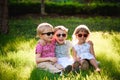 Smiling kids at the garden in sunglasses