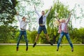 Smiling kids having fun and jumping at grass. Children playing outdoors in summer. teenagers communicate outdoor Royalty Free Stock Photo