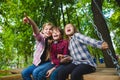 Smiling kids having fun at playground. Children playing outdoors in summer. Teenagers riding on a swing outside