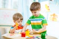 Smiling kids play and paint at home or Royalty Free Stock Photo