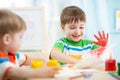 Smiling kids playing and painting Royalty Free Stock Photo